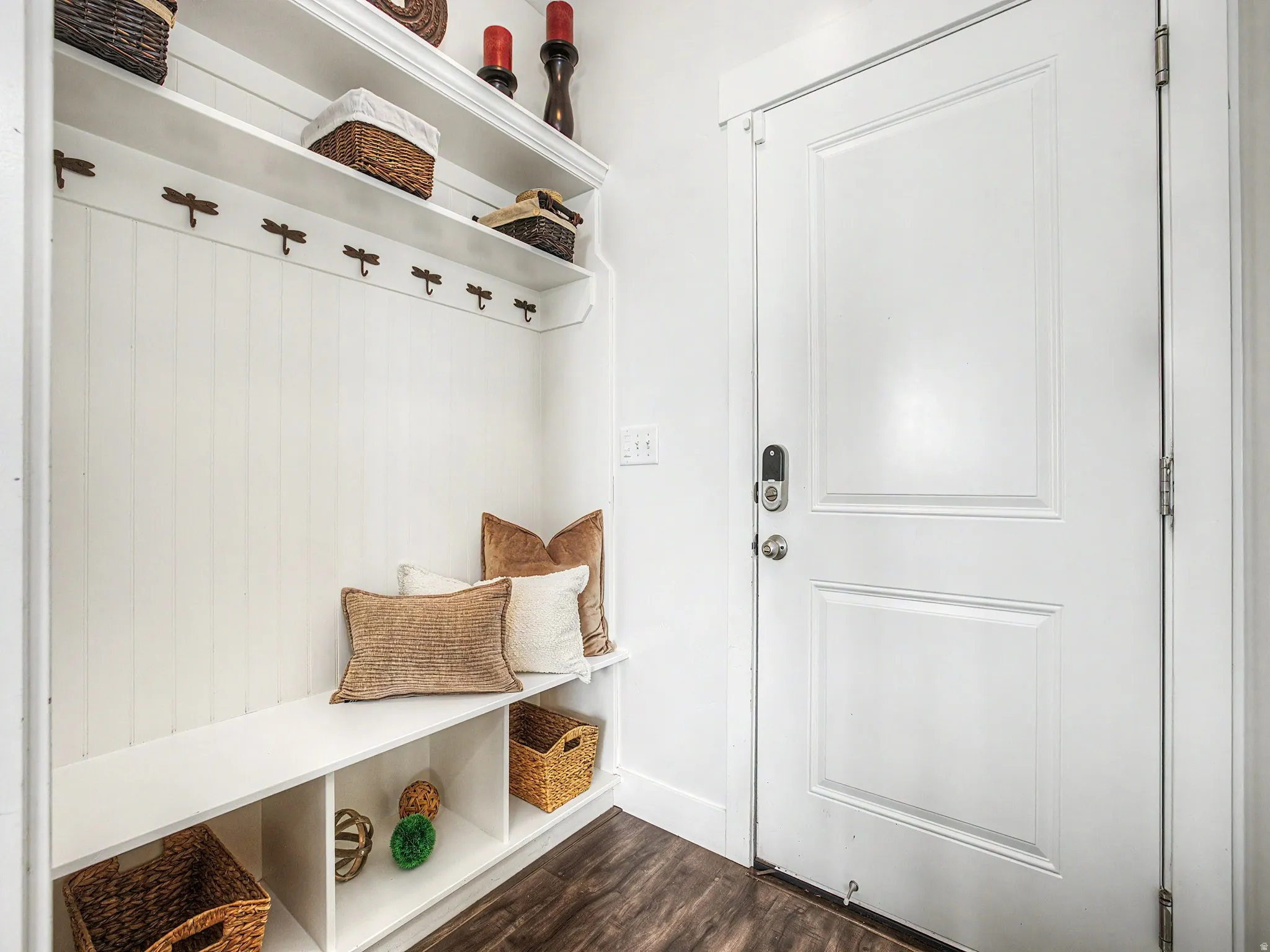 Mudroom with dark wood-style floors and baseboards