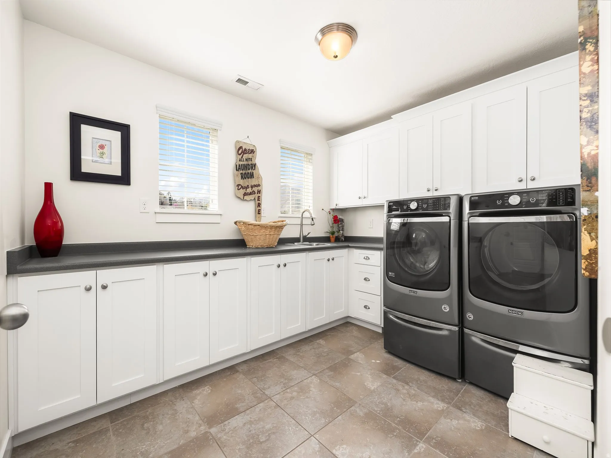 Laundry area with cabinet space and washing machine and dryer