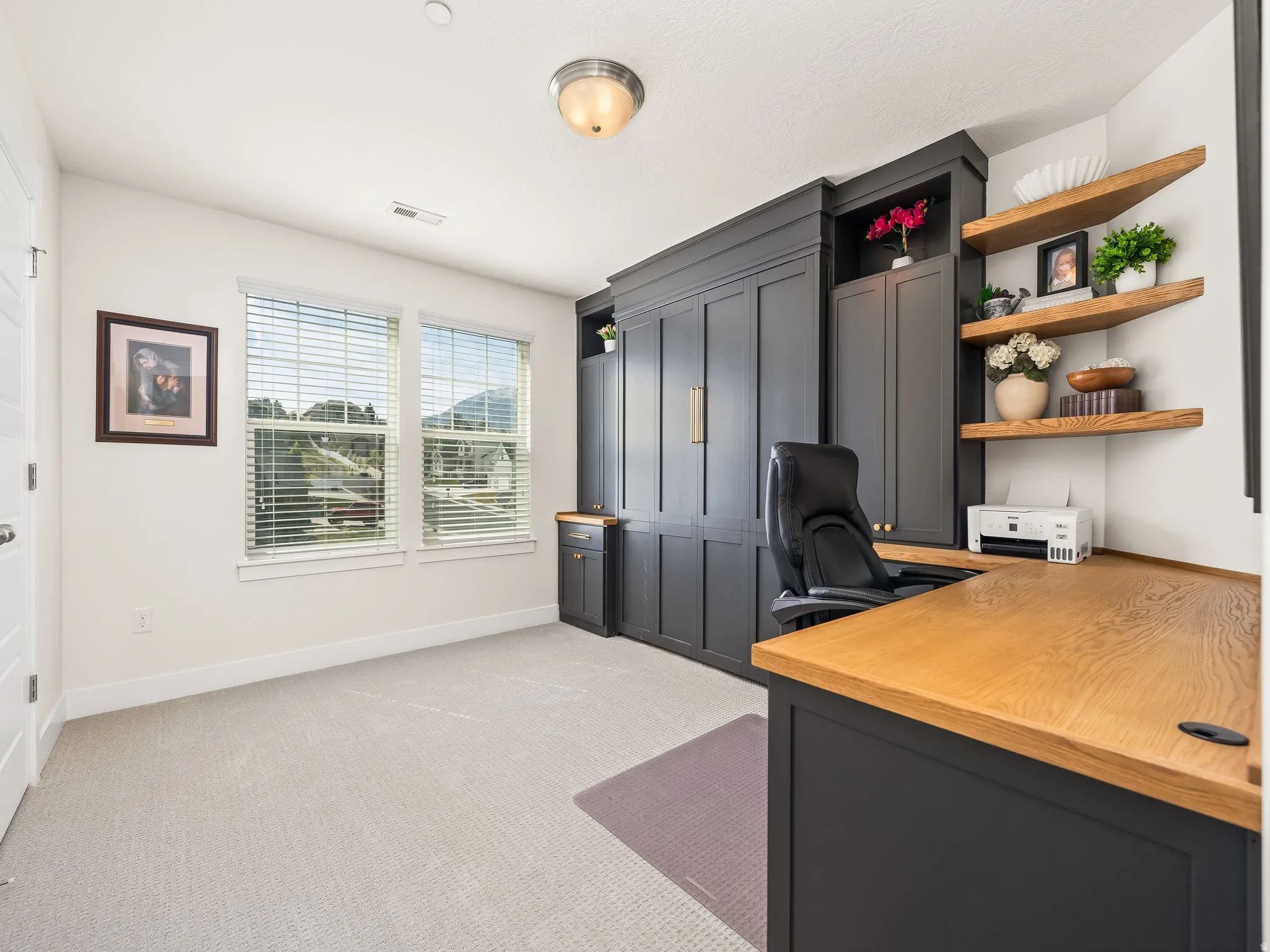 Office featuring light carpet and baseboards