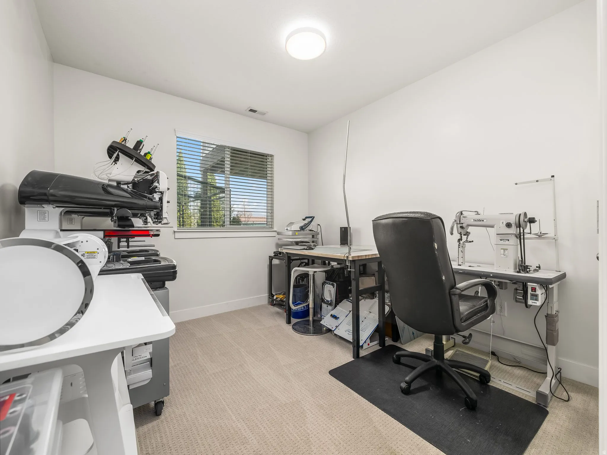 Home office featuring light carpet and baseboards