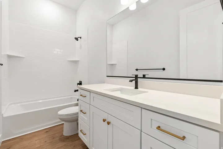 Full bathroom with vanity, light wood-style floors, and shower / tub combination