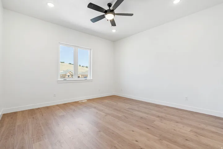 Unfurnished room featuring light wood-type flooring, recessed lighting, and ceiling fan