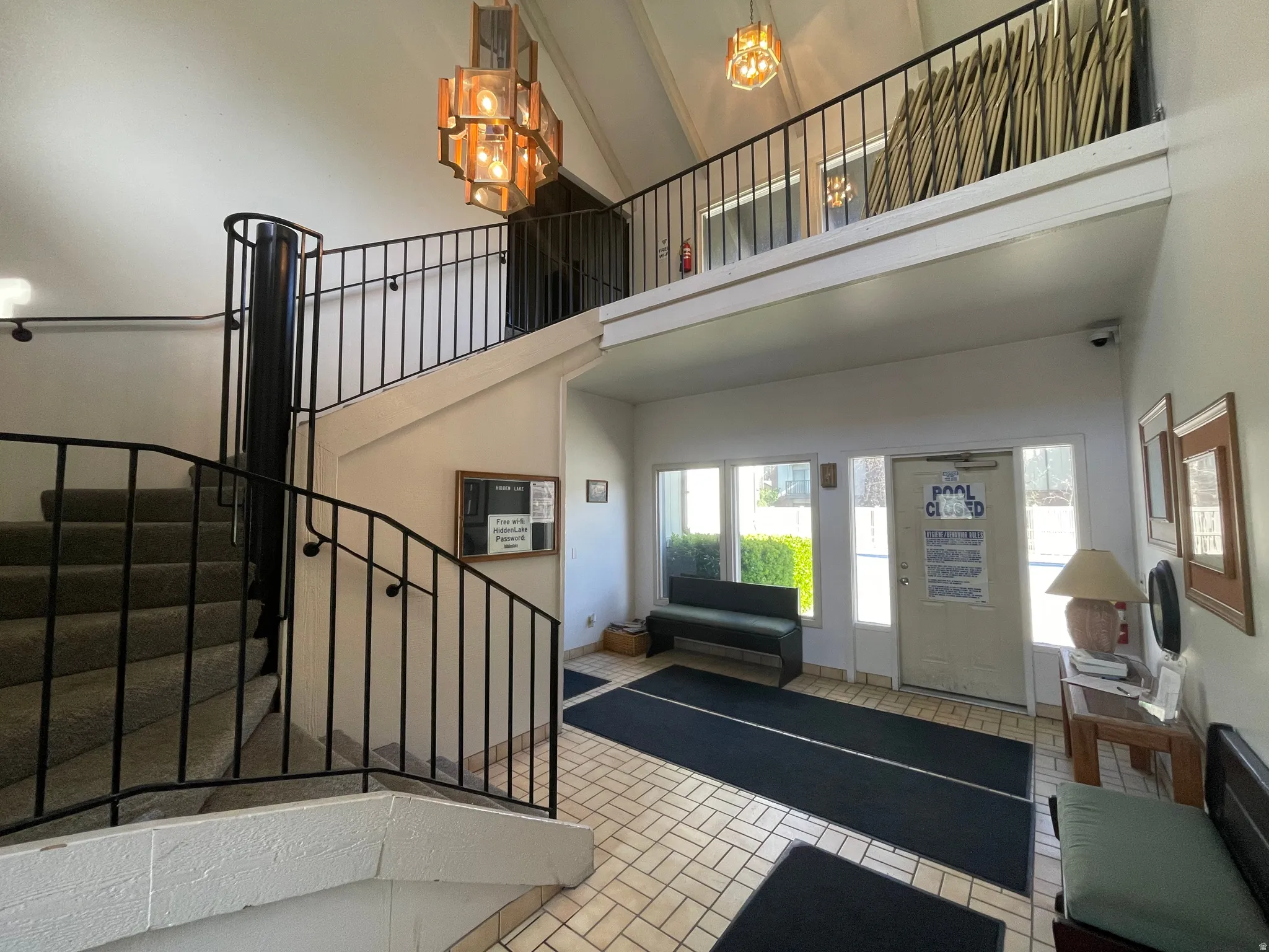 Foyer featuring a high ceiling and a chandelier and access to large outdoor pool