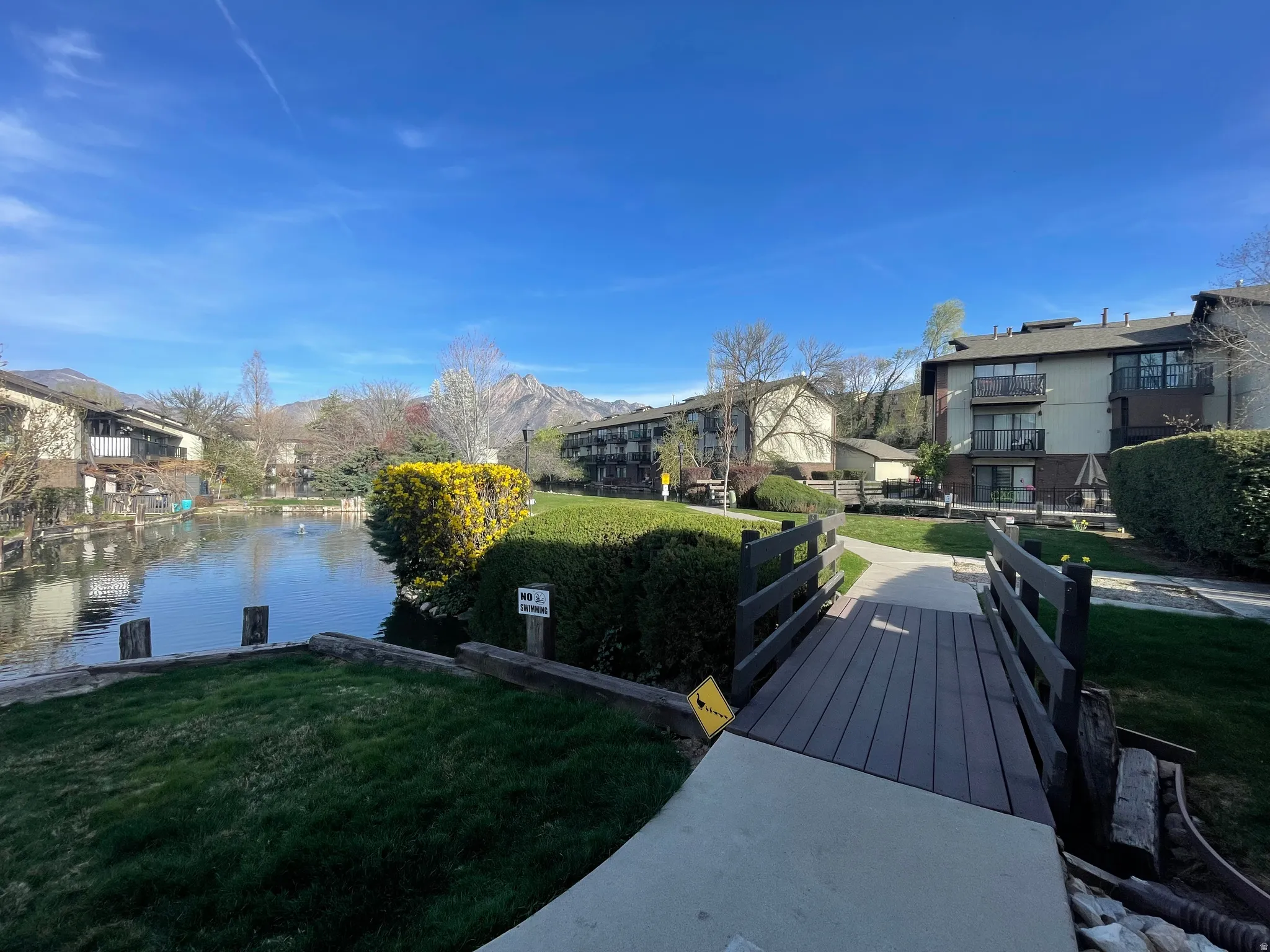 Clubhouse exterior community area with a bridge and a water view