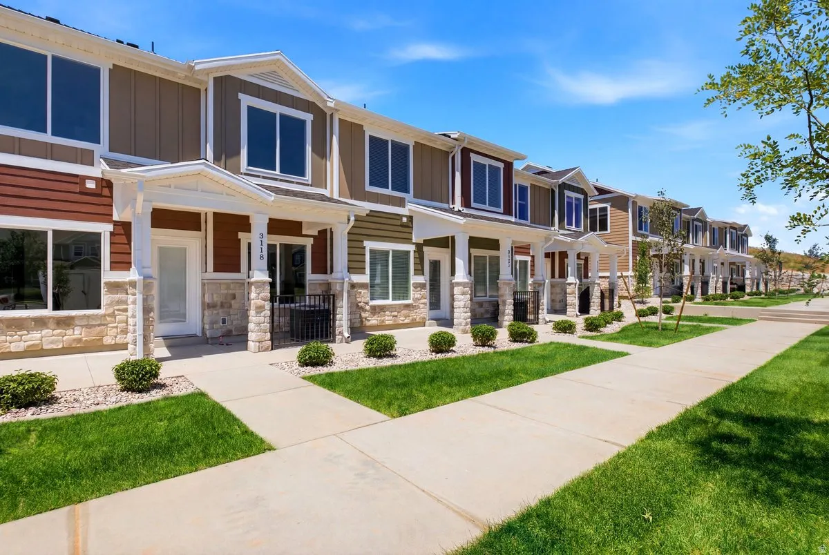 Contemporary townhome exteriors featuring varied siding materials and stone accents