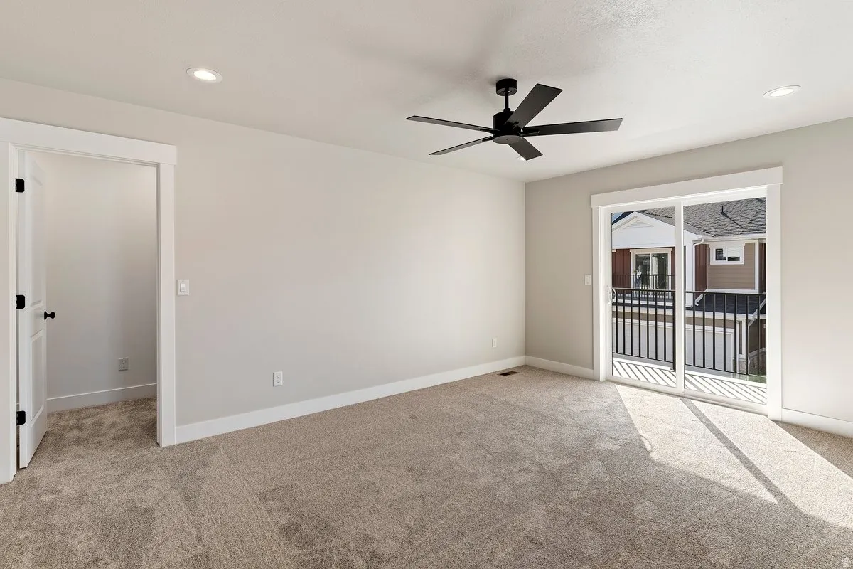 Empty room featuring ceiling fan, light colored carpet, and recessed lighting
