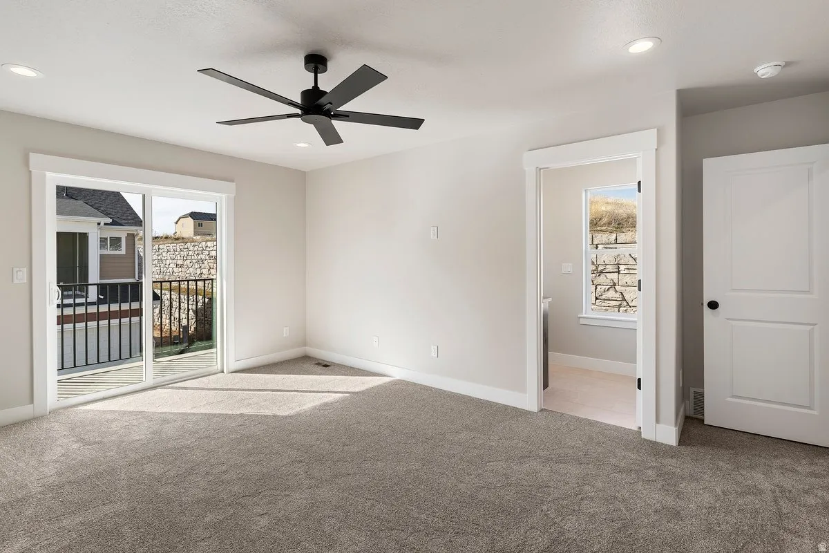 Unfurnished bedroom with light carpet, a ceiling fan, access to outside, and recessed lighting