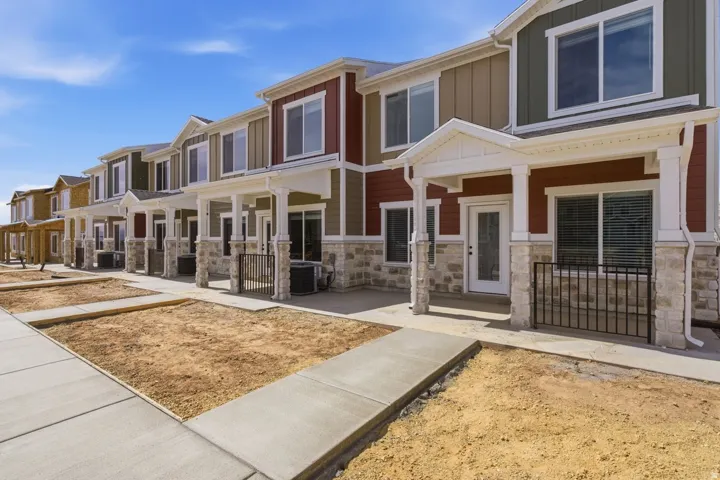 View of front facade featuring stone siding, a porch, board and batten siding, and a residential view