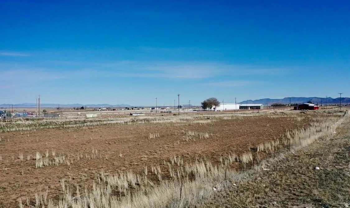View of yard with a rural view and a mountain view