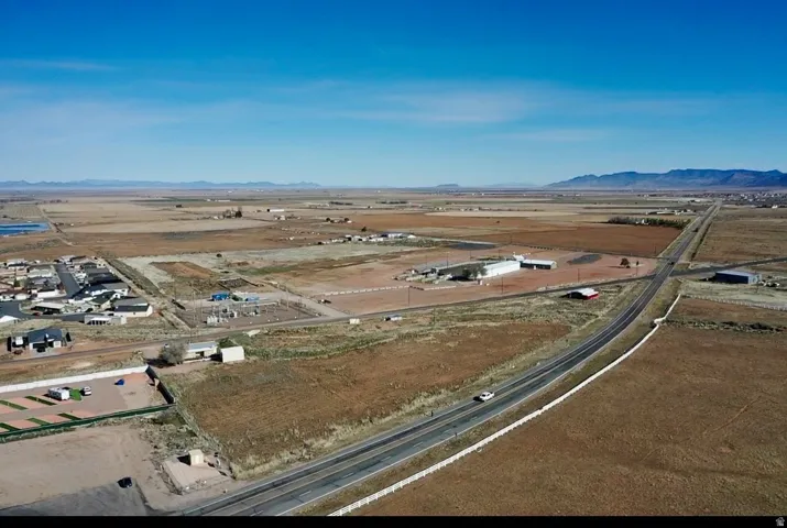 Aerial view of property and surrounding area with mountains and rural landscape