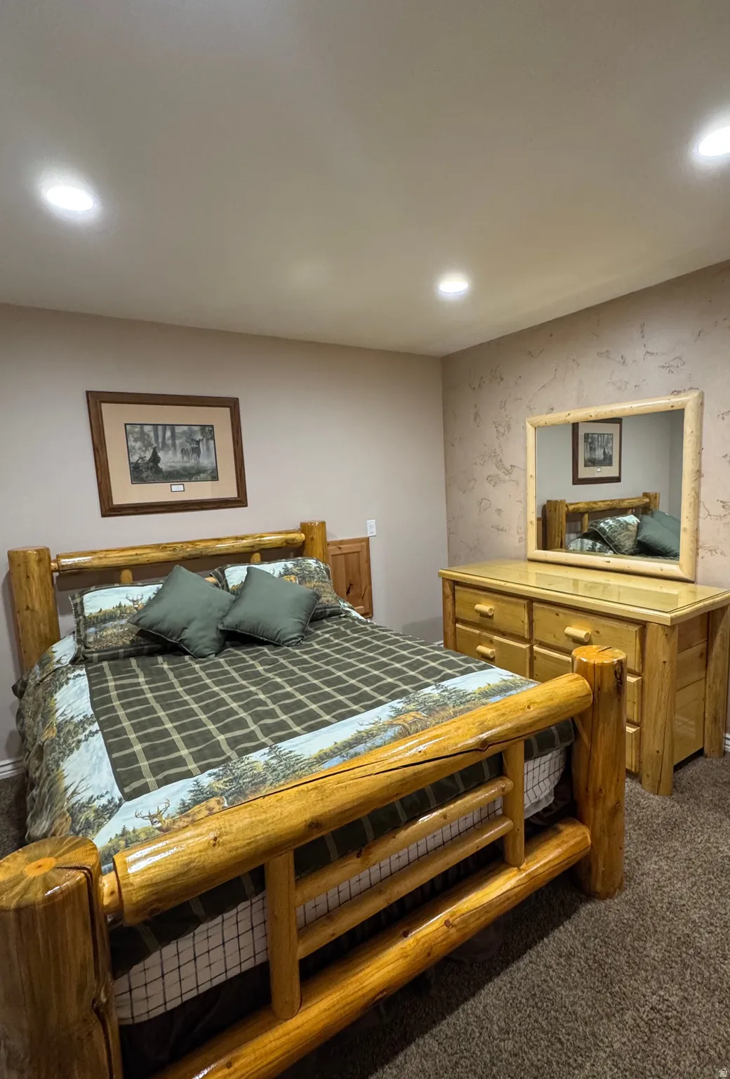 Bedroom featuring dark carpet, recessed lighting, and wallpapered walls