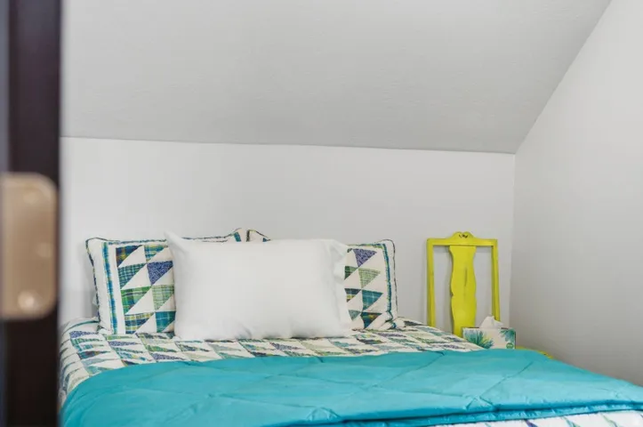 Bedroom with lofted ceiling