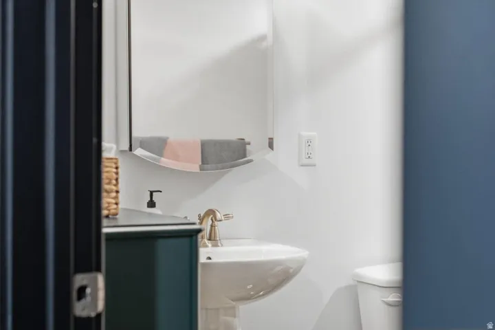 Half bath featuring toilet and a sink