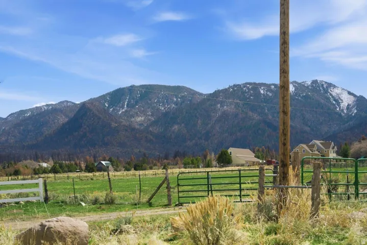 View of mountain backdrop with rural landscape