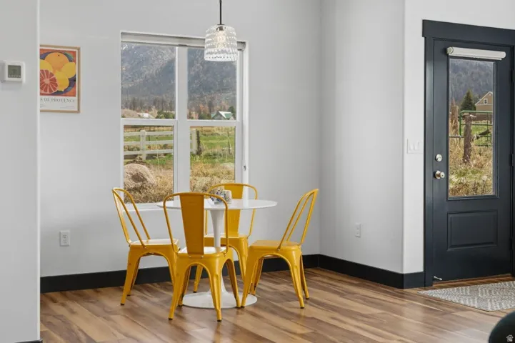 Dining space with wood finished floors and plenty of natural light