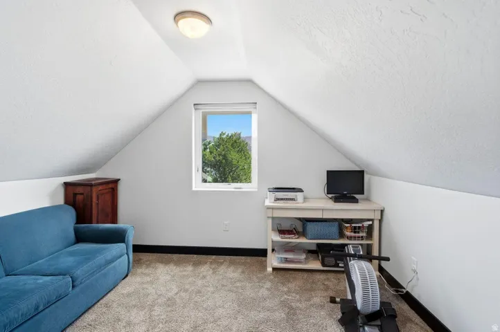 Office space with carpet floors and a textured ceiling
