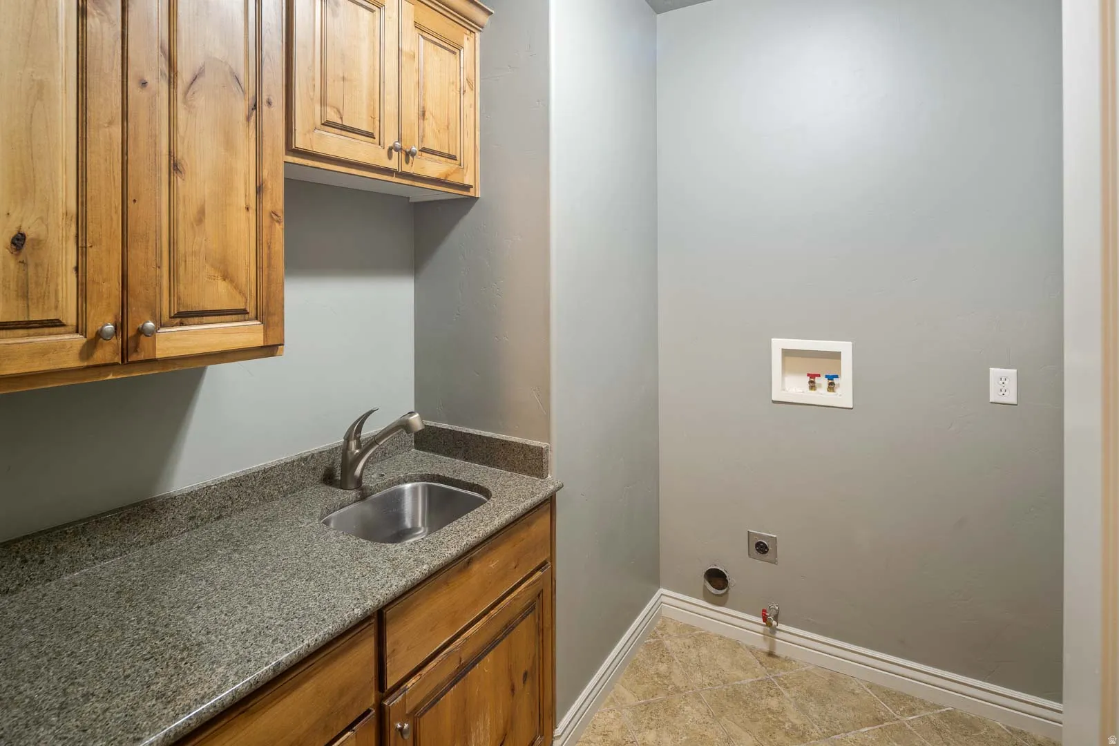 Laundry area with hookup for a washing machine and cabinet space