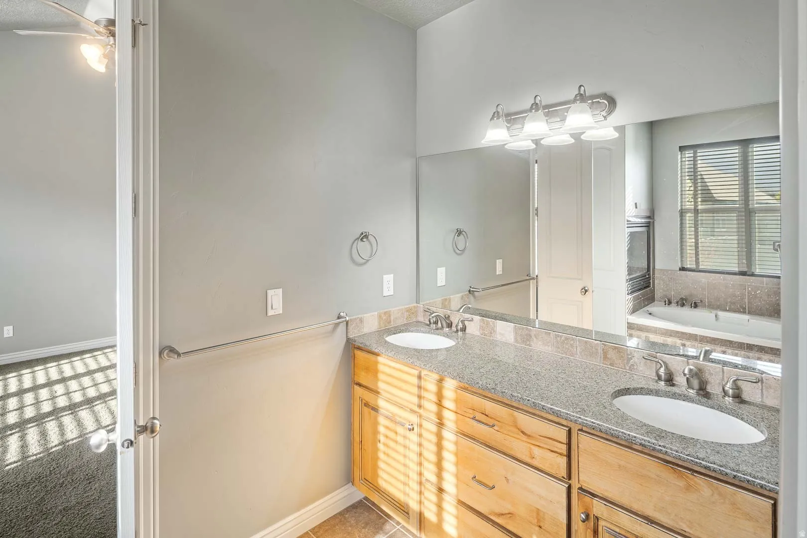 Bathroom with double vanity and a bath