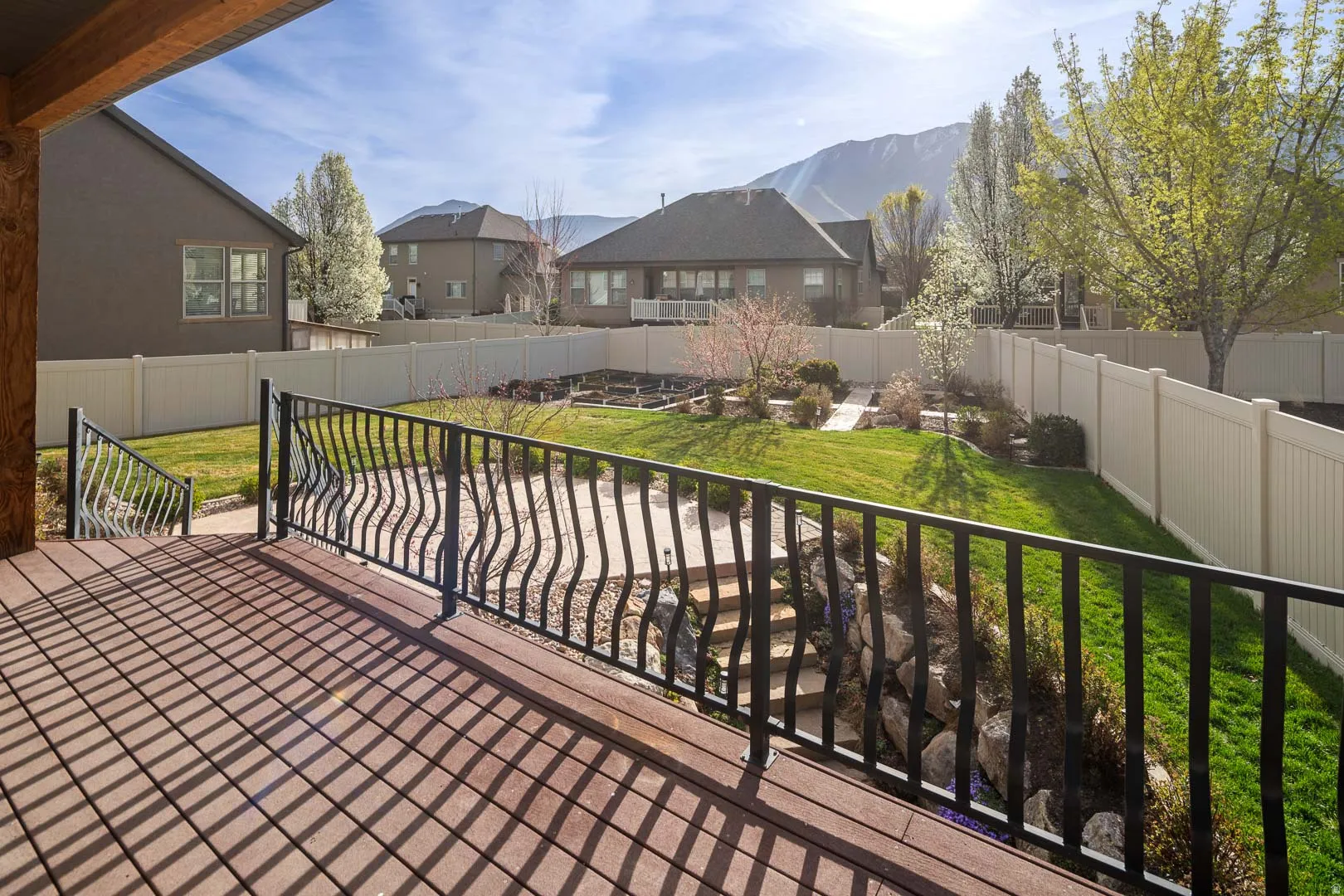 Wooden terrace featuring a fenced backyard, a patio area, and a residential view