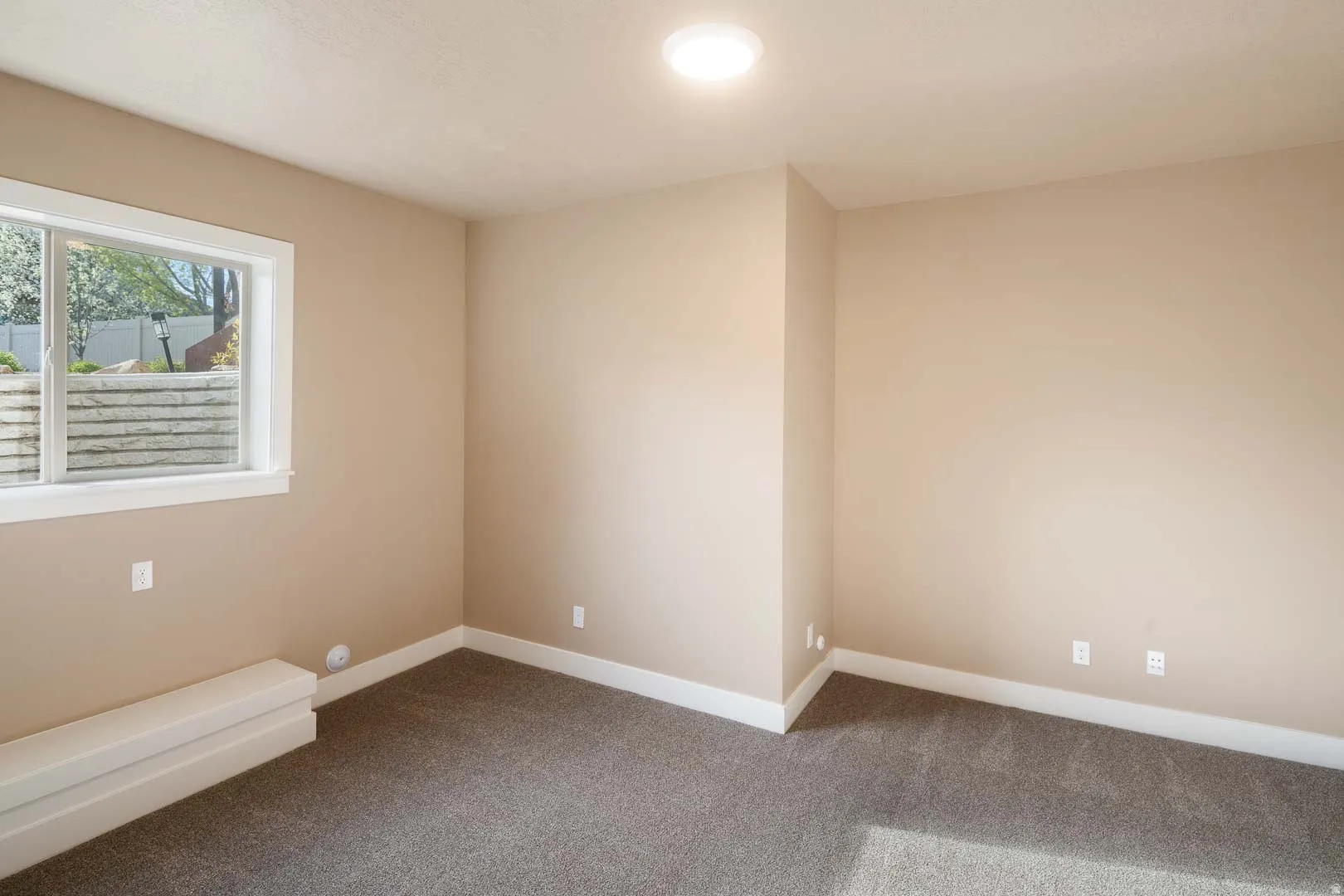 Spare room with baseboards and carpet