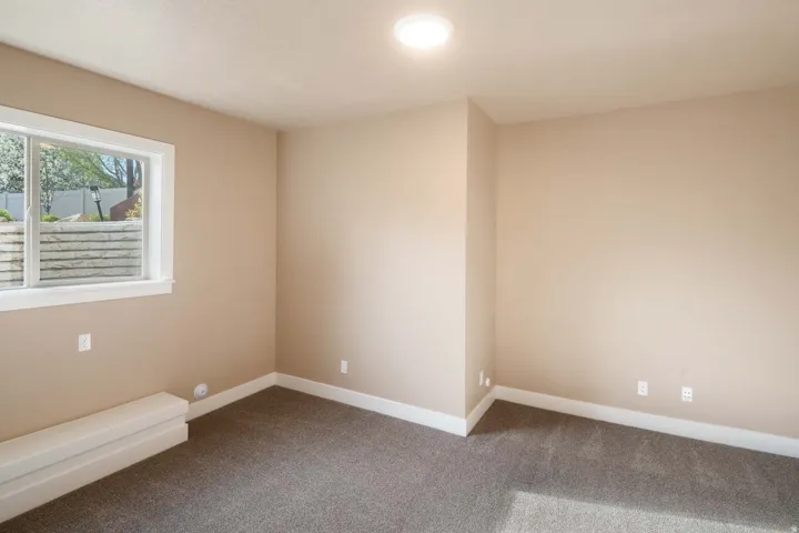 Spare room with baseboards and carpet