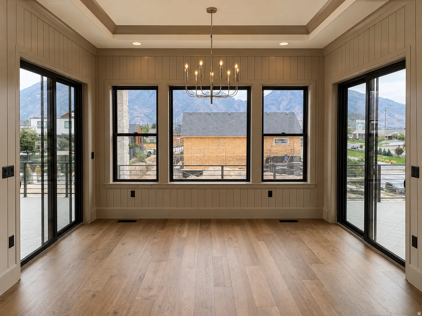 Tray ceiling with recessed lighting and a chandelier