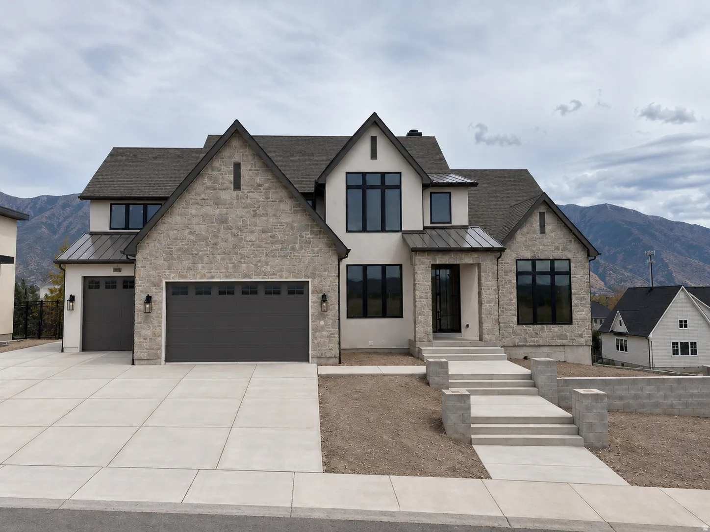 Modern stucco and stone facade with dark-framed windows