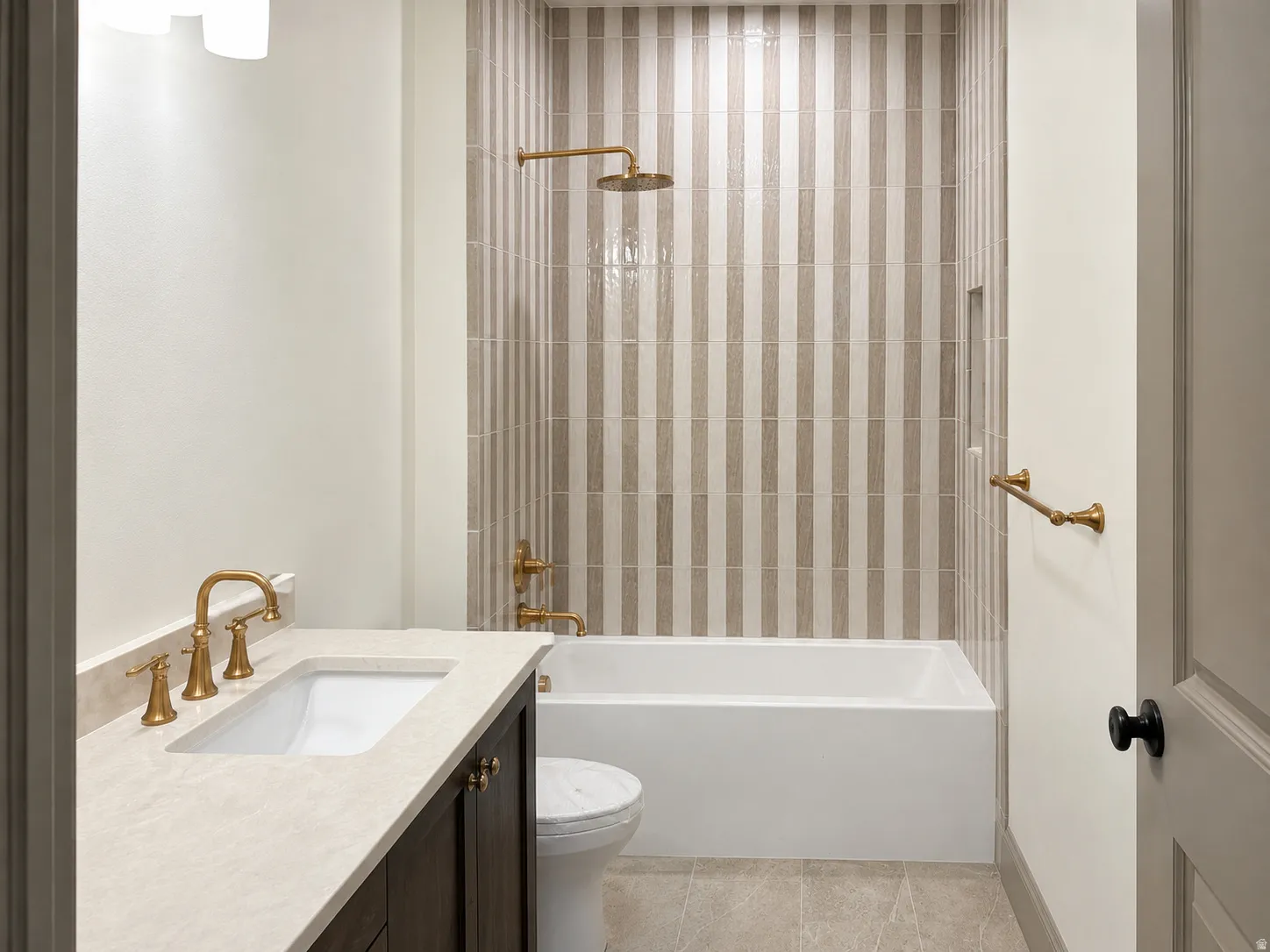 Bathroom featuring a built-in tub with a brass rain showerhead and coordinating hardware