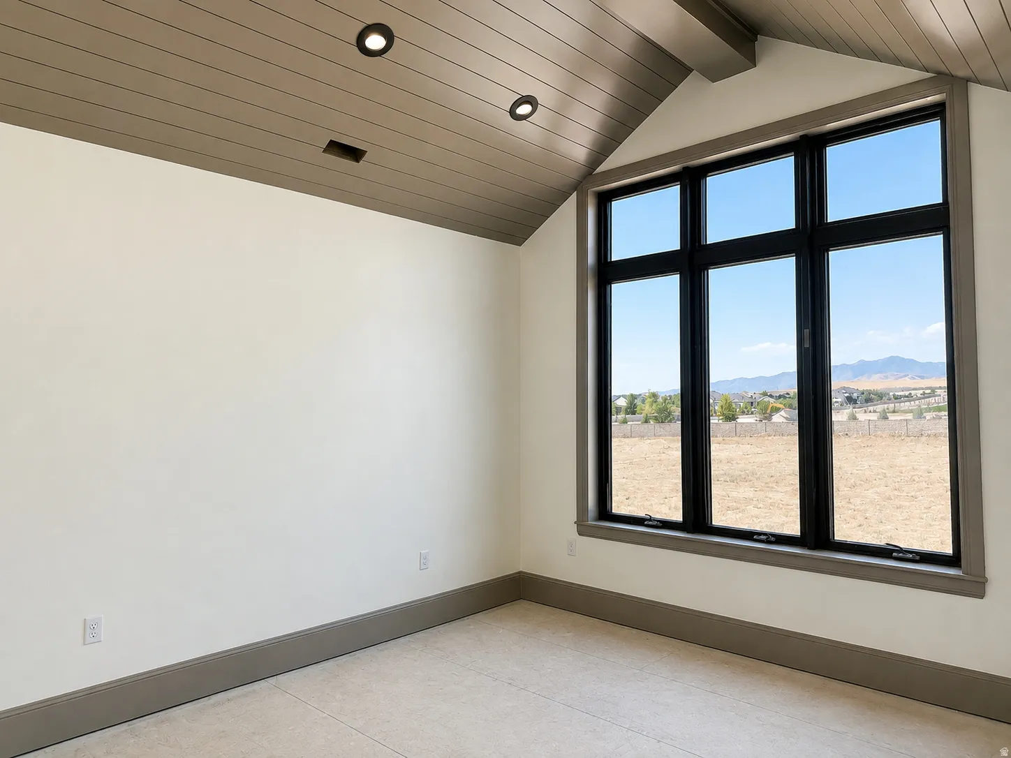 Vaulted ceiling with wood-finish planks and recessed lighting