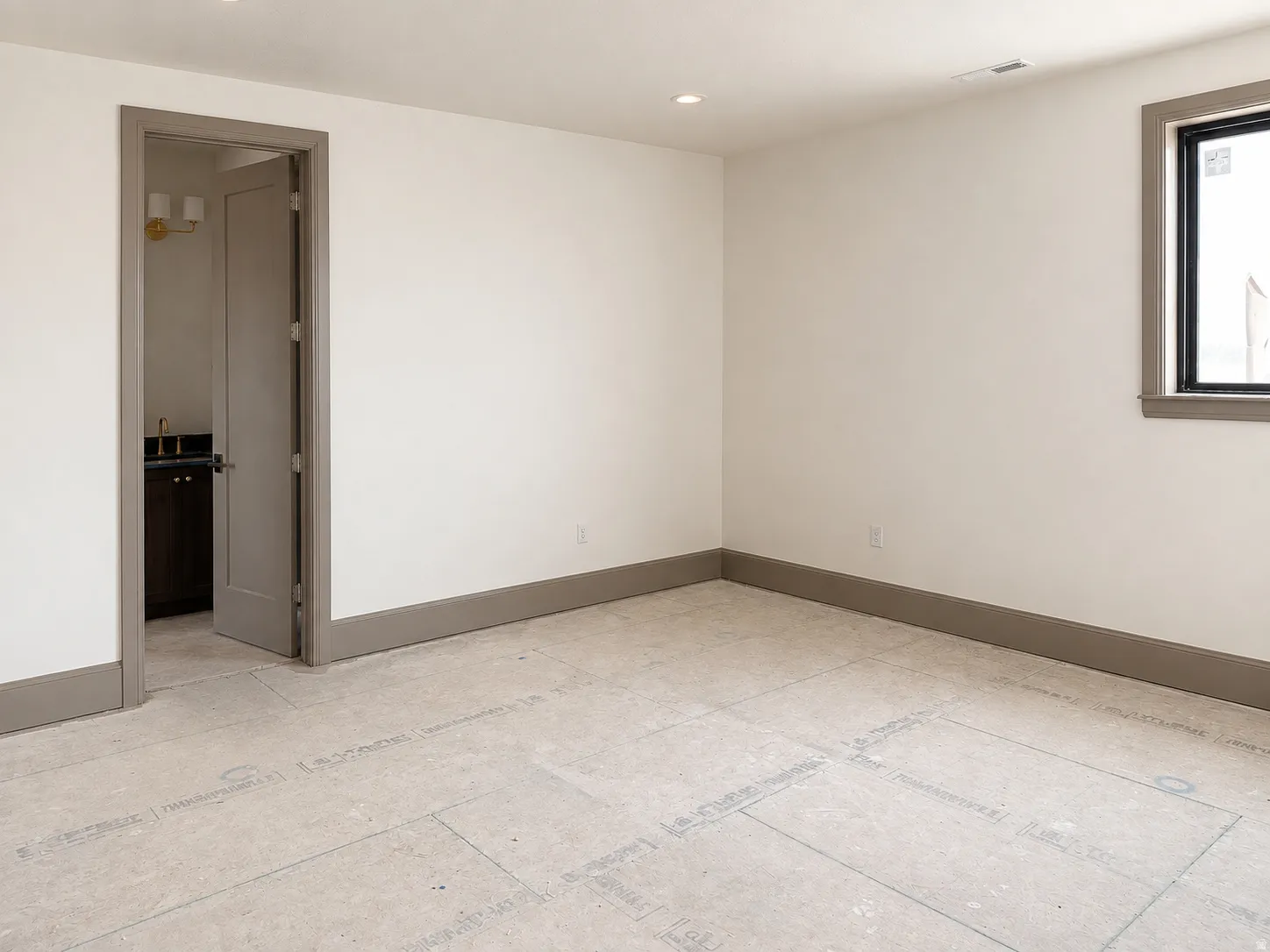 Room featuring neutral wall finishes and contrasting baseboards
