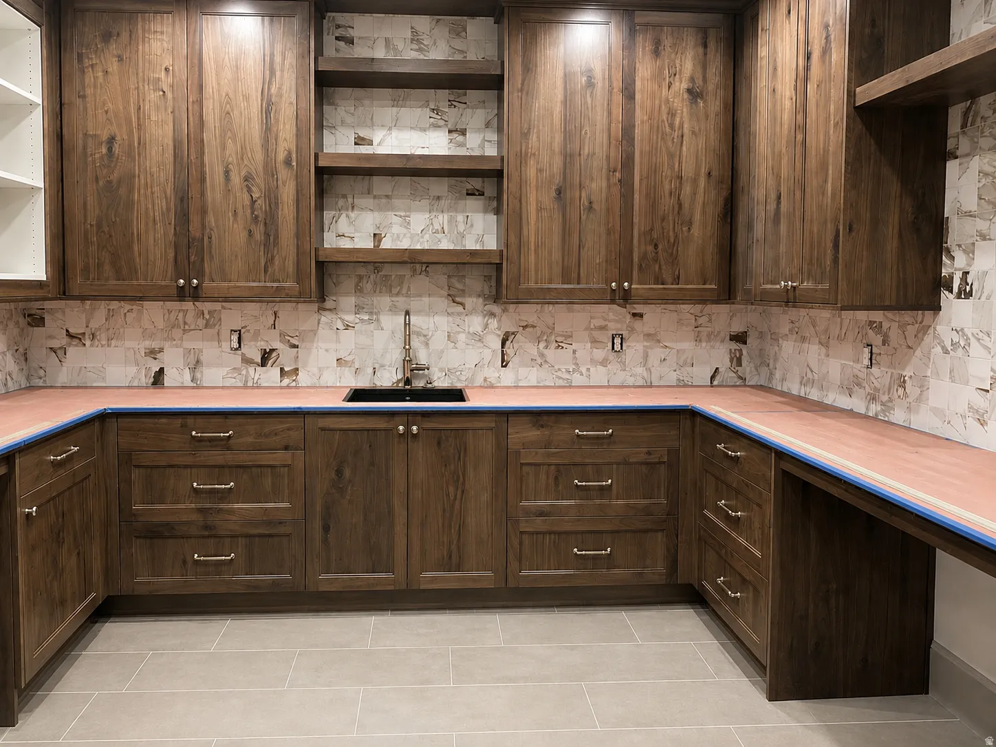 Extensive wood-finish cabinetry with a built-in sink and open shelving