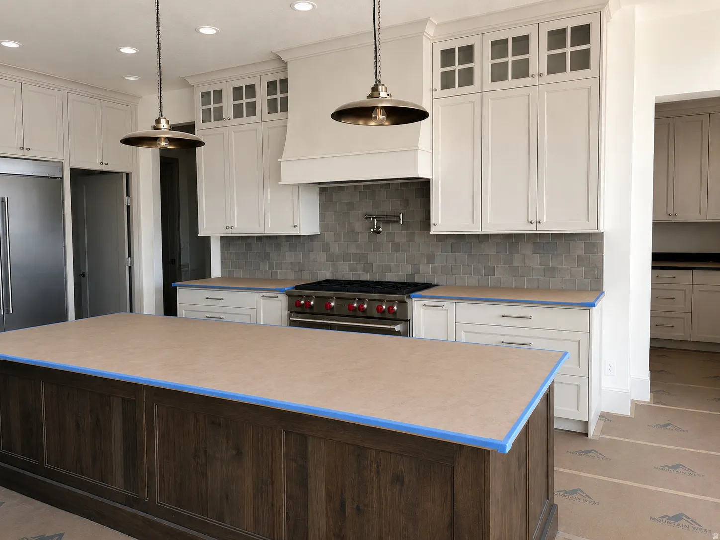Expansive kitchen island with dark wood-finish paneling