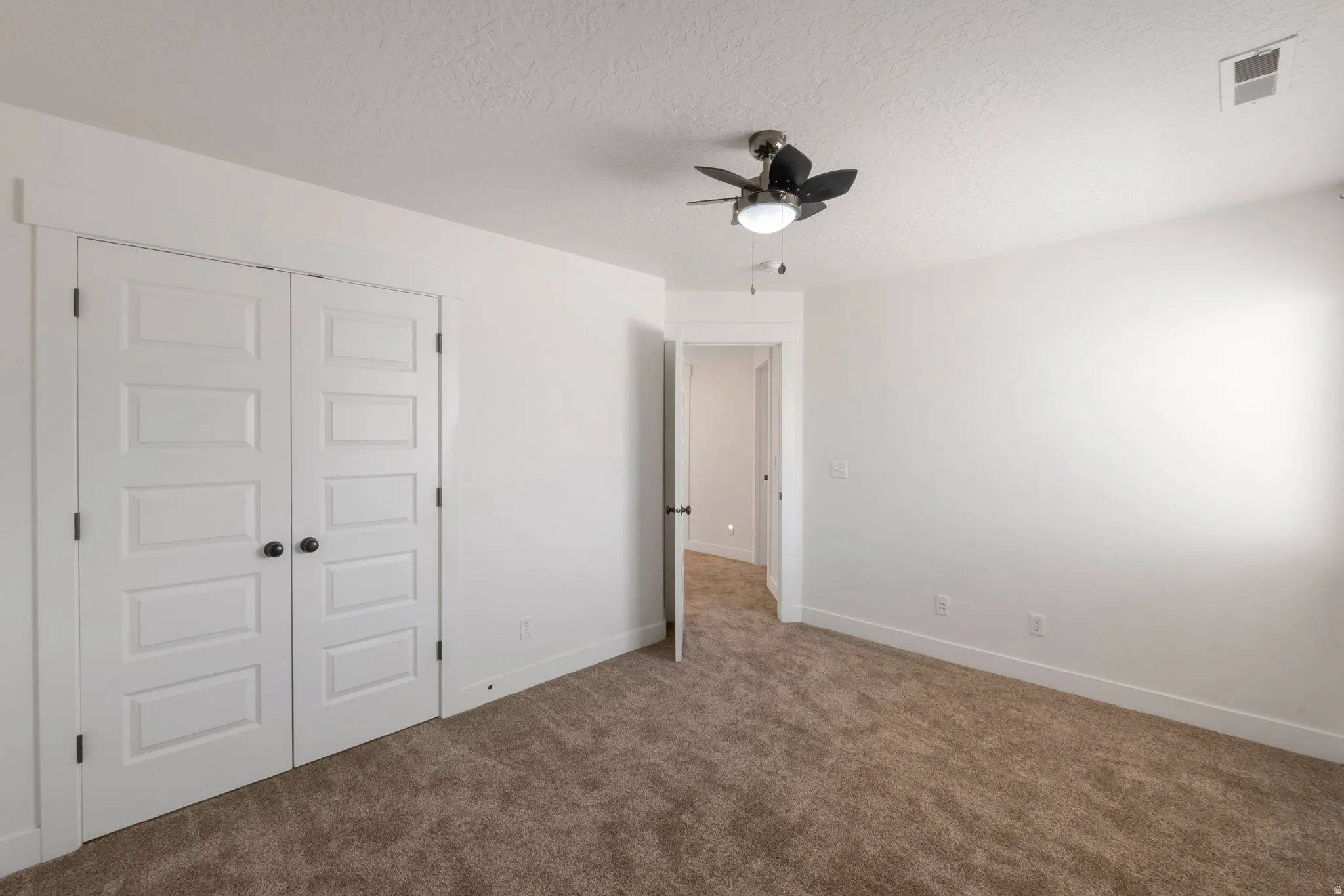 Neutral-toned carpeting paired with white walls