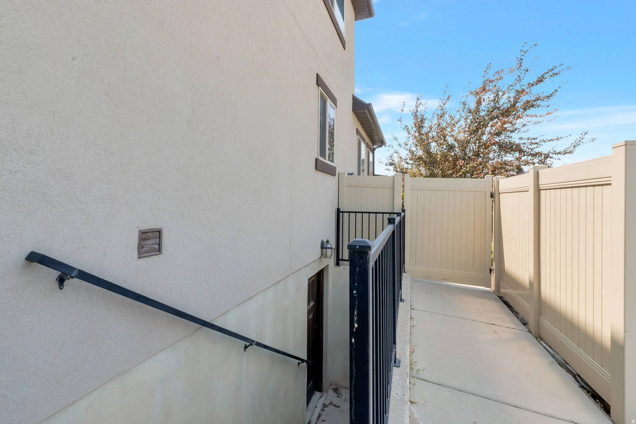 Exterior stucco finish with a contrasting dark fascia