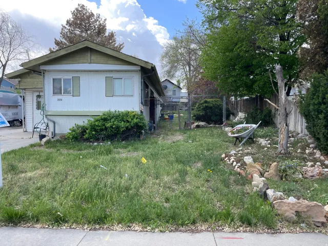 View of property exterior featuring a gate