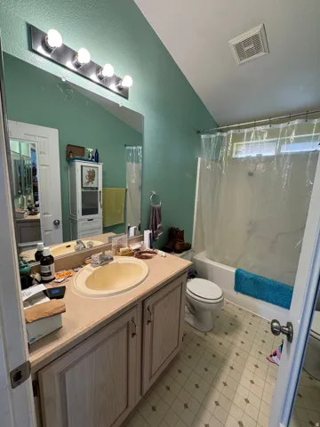 Bathroom featuring a vanity with an integrated sink, a rectangular mirror, and a five-light fixture