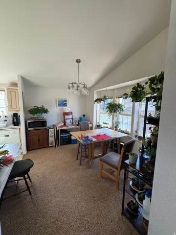 Dining area with vaulted ceilings and a multi-pane window bay