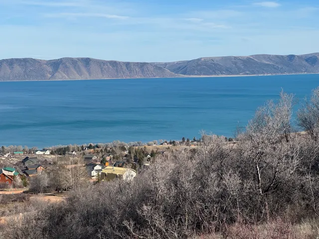 Water view featuring mountains and nearby suburban area