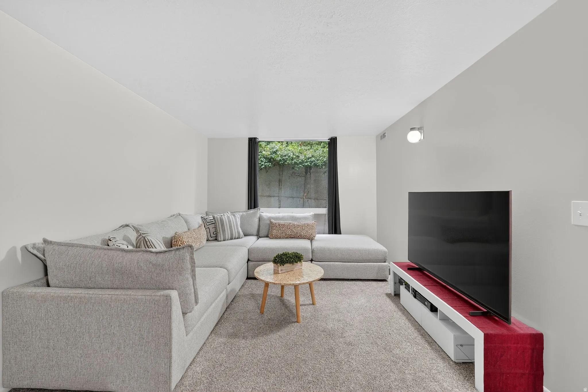 Living room featuring expansive windows and light colored carpet