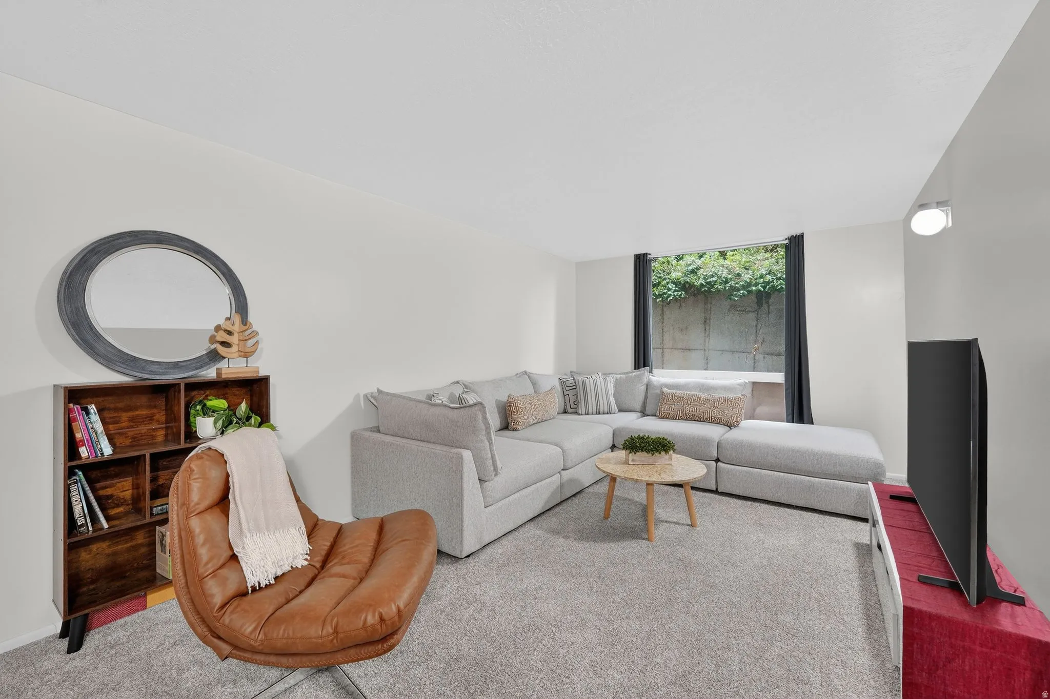 Carpeted living room with floor to ceiling windows