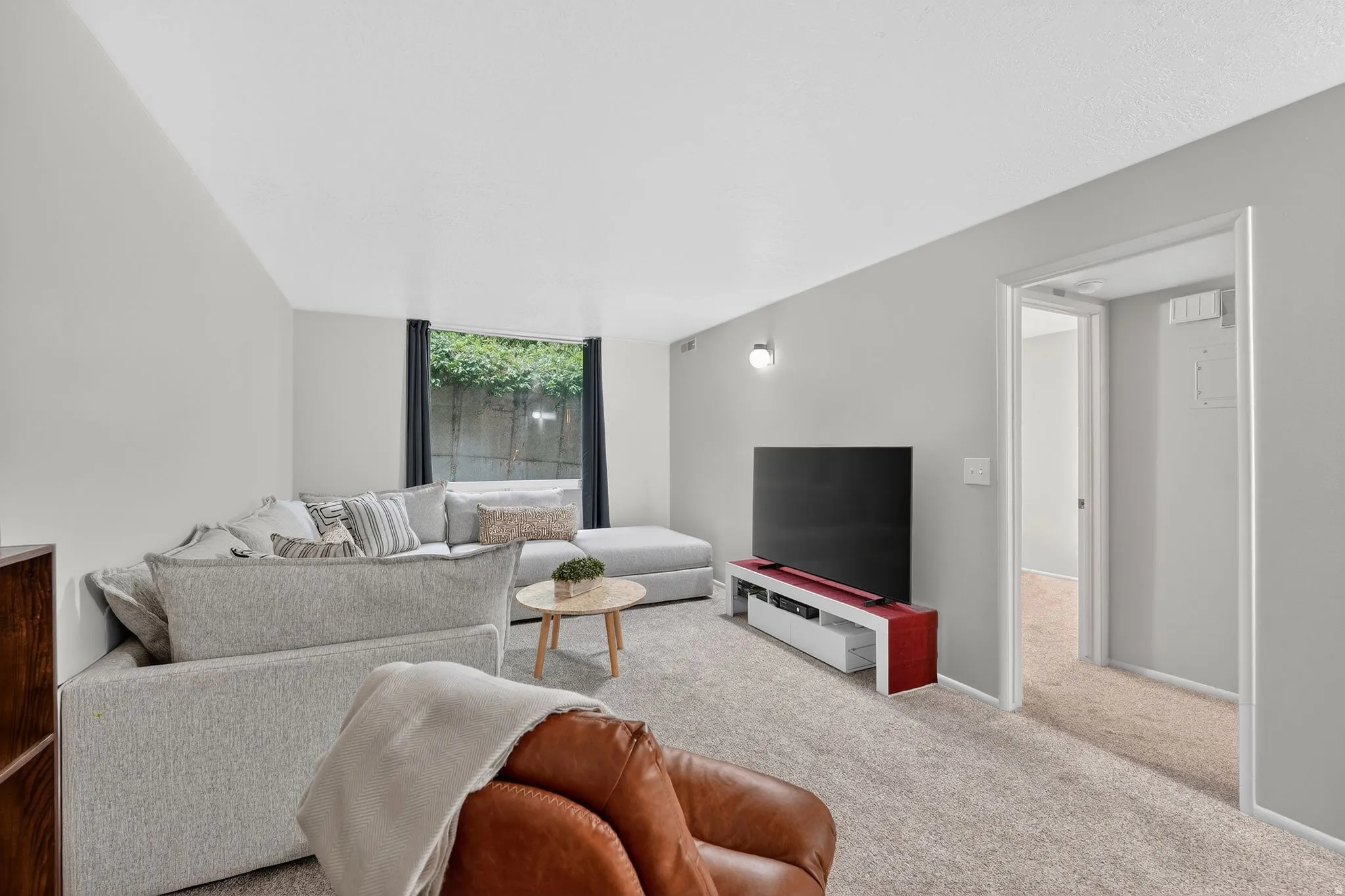 Living room featuring light carpet and floor to ceiling windows