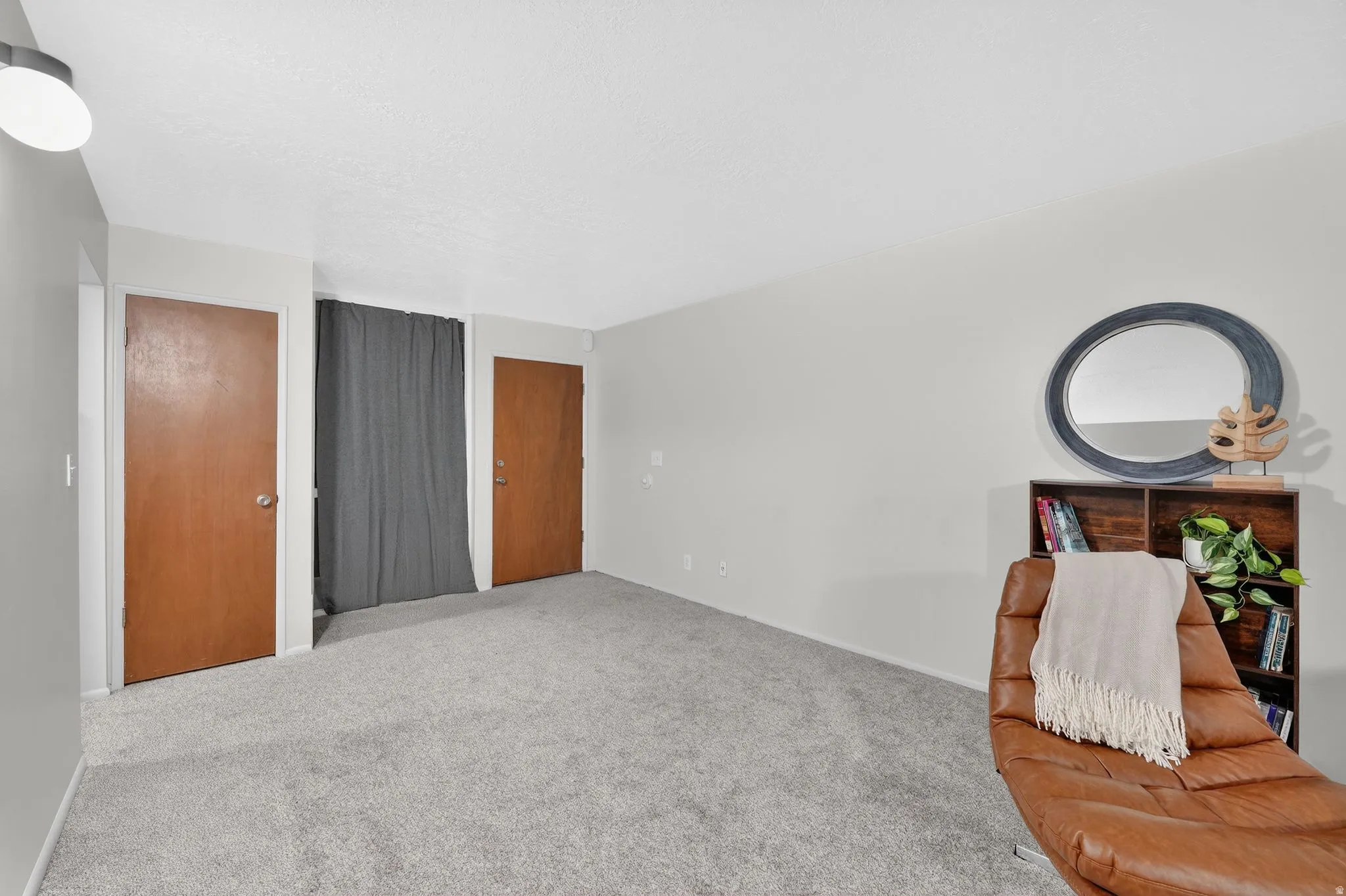 Sitting room featuring carpet and baseboards