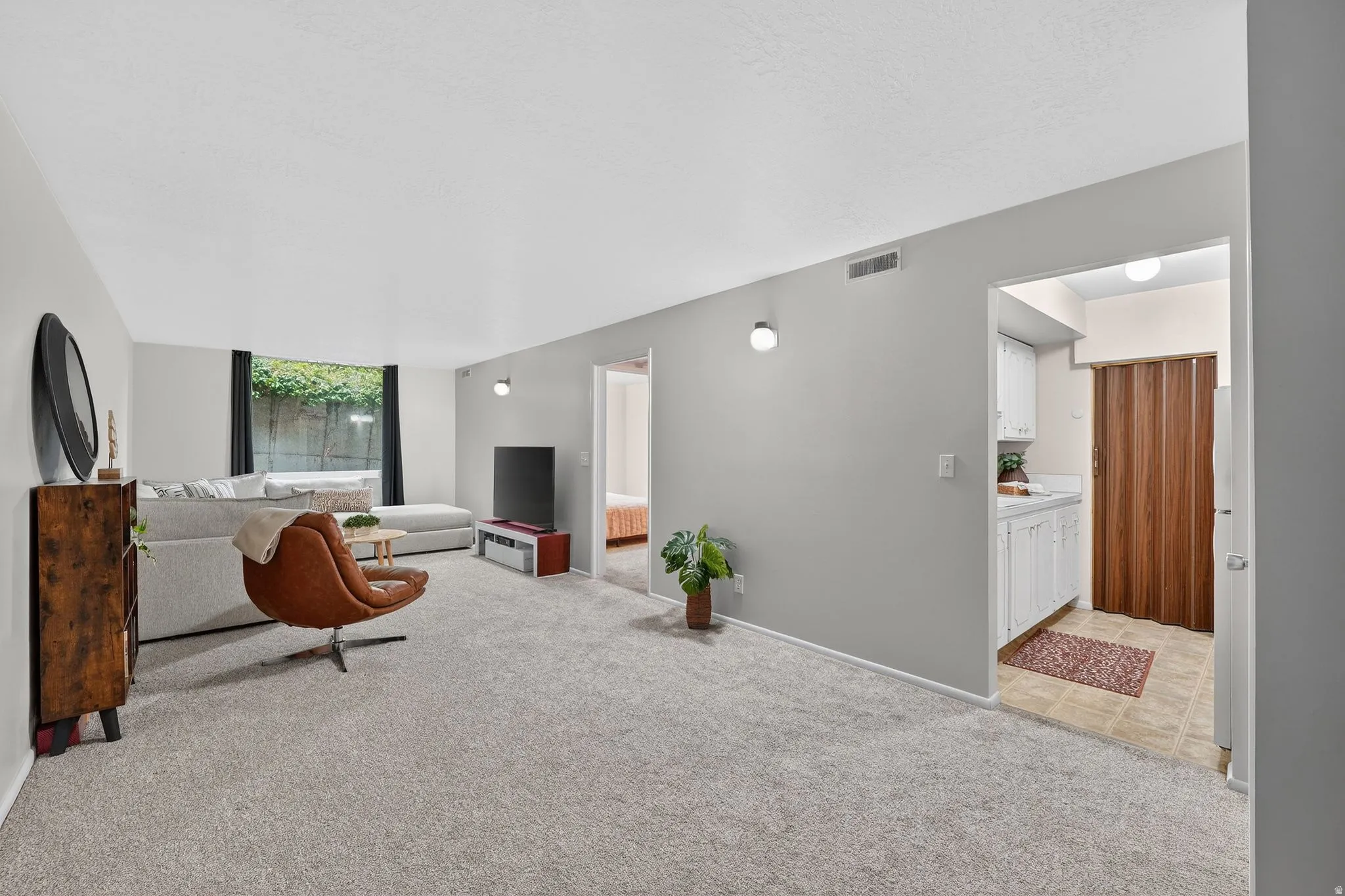 Living room featuring light carpet and baseboards