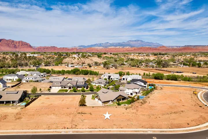 Aerial perspective of suburban area with a mountainous background