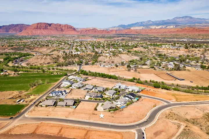 Overview of rural landscape featuring a mountain backdrop and nearby suburban area