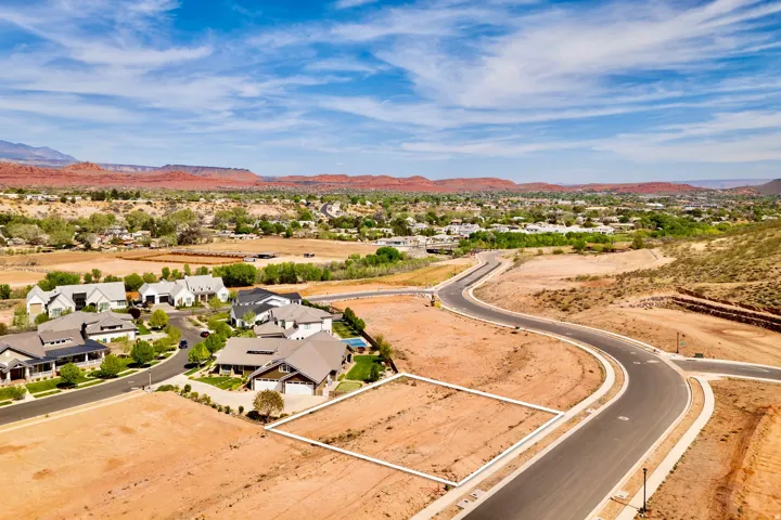 Aerial view of residential area with a mountainous background and a desert landscape
