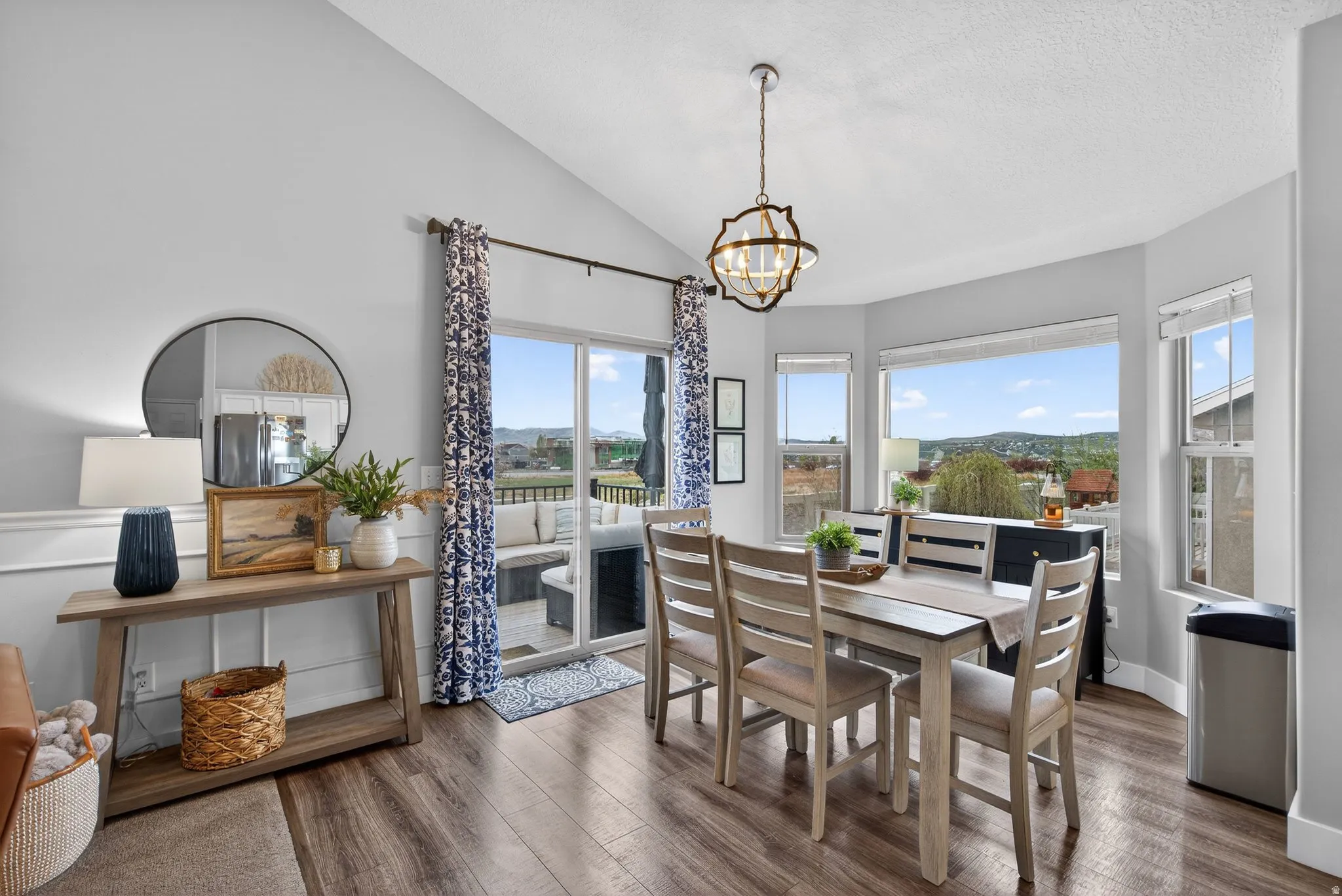 Dining room featuring hanging lights, lofted ceiling, and wood finished floors