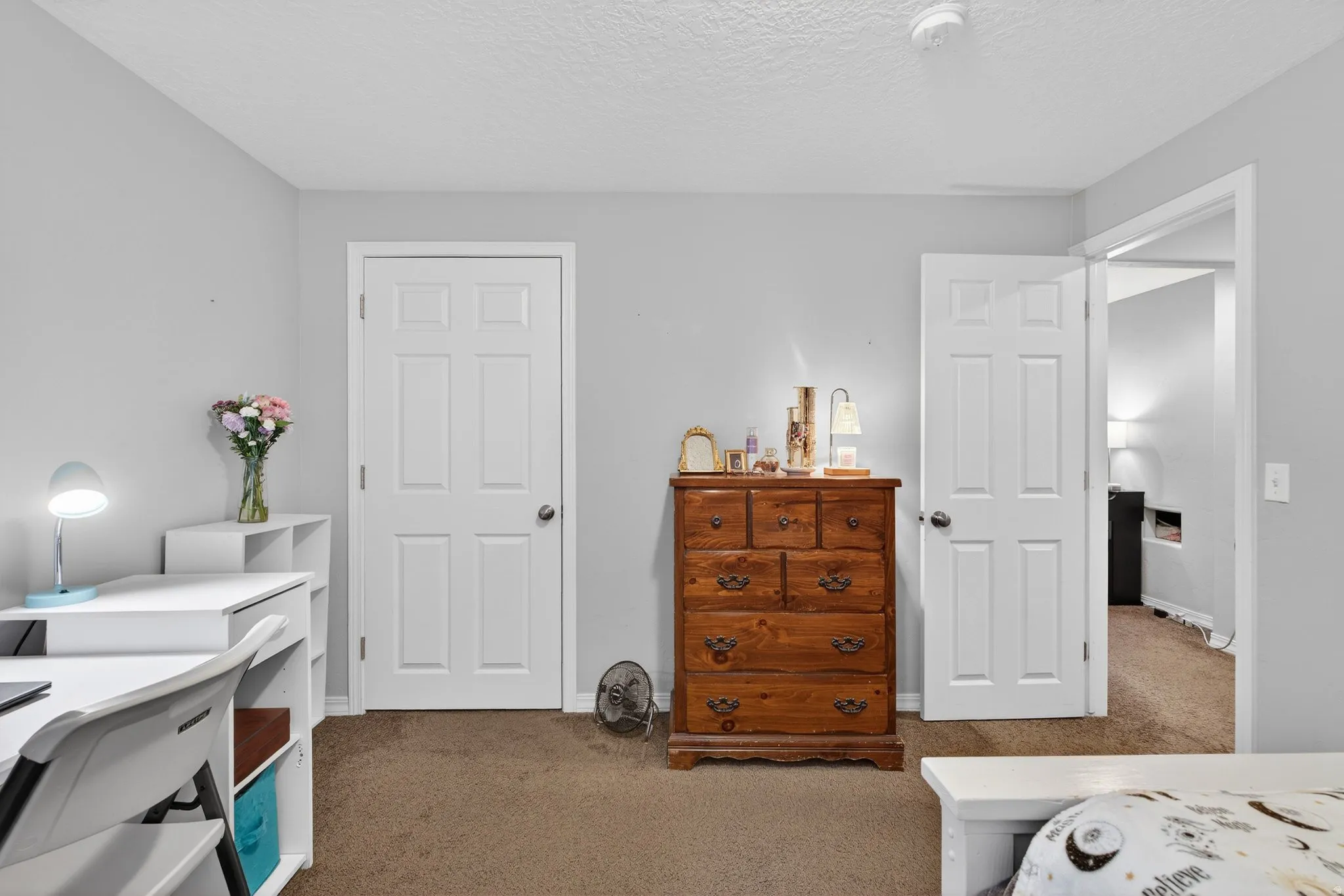Bedroom featuring carpet floors and a textured ceiling