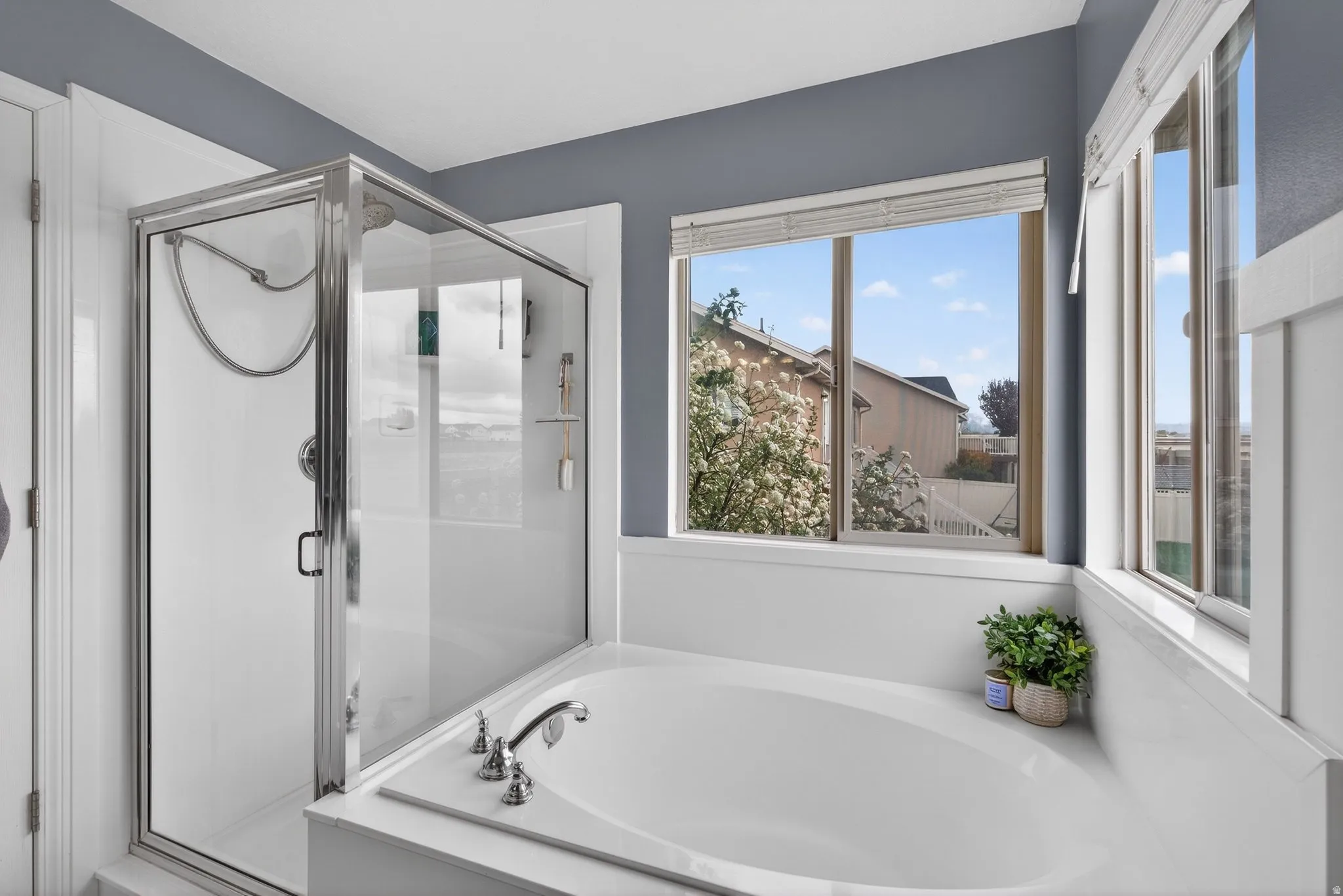 Full bathroom with a stall shower and a bath