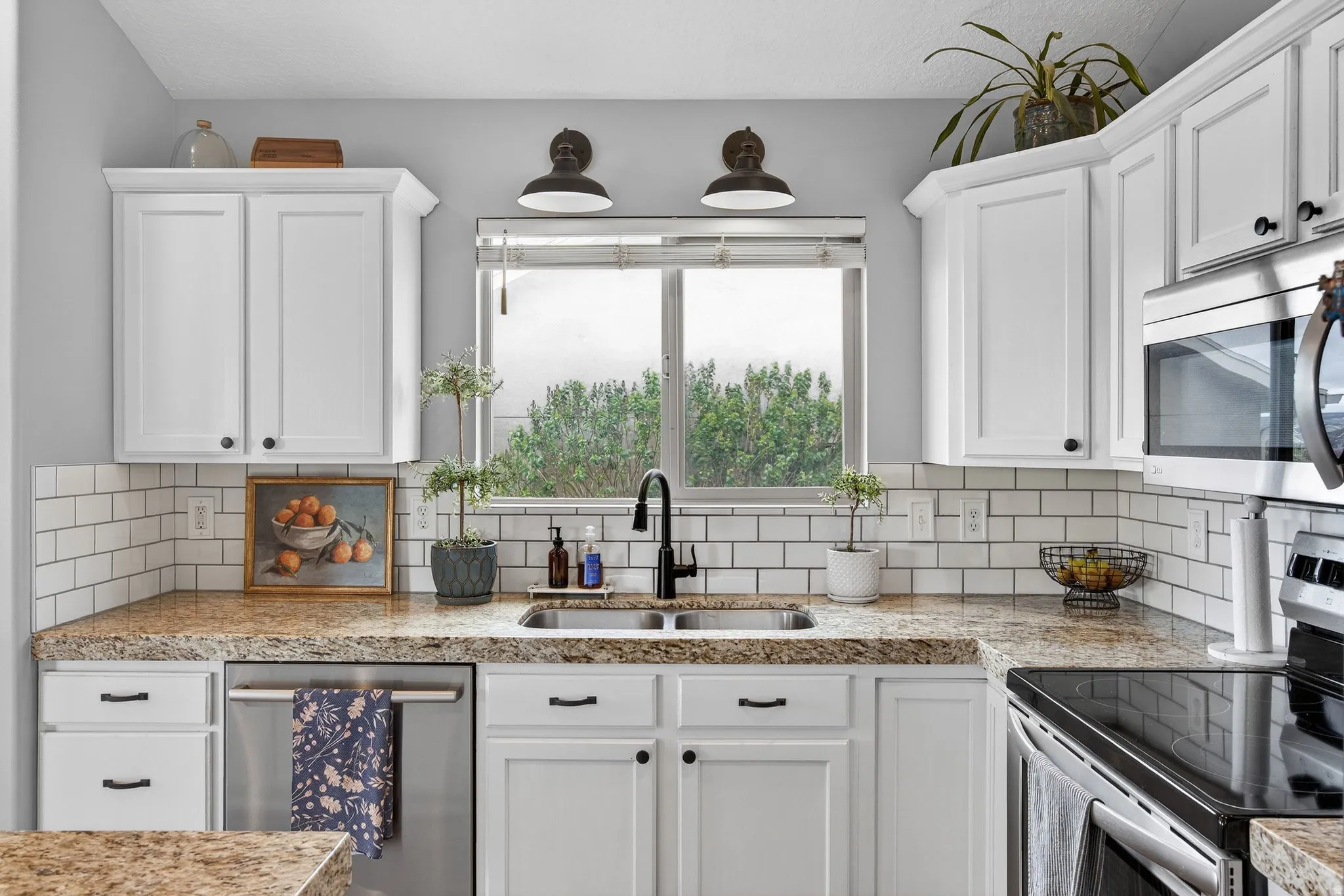 Kitchen with stainless steel appliances and white cabinetry